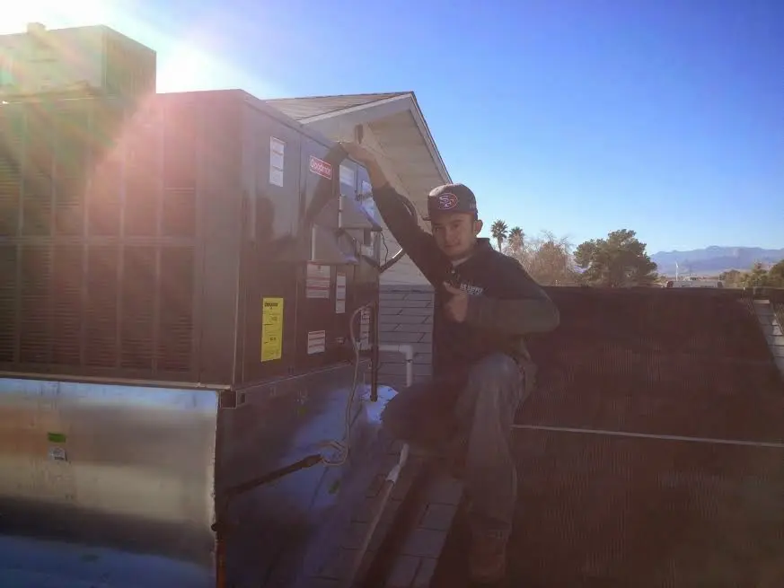 HVAC technician performing HVAC Inspection on a rooftop unit in Crestview